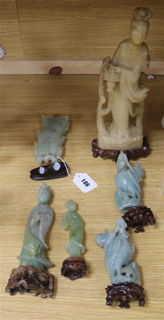 A Chinese celadon jade magnolia blossom, a jadeite figure of Guanyin, a pair of jadeite birds, a large soapstone figure of a lady and a